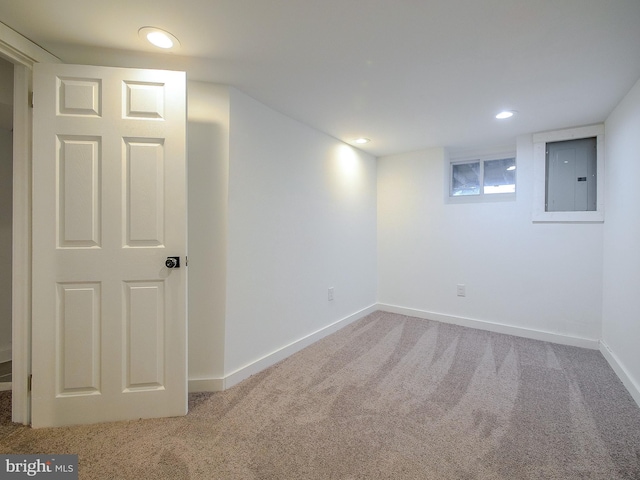 basement with carpet flooring and electric panel