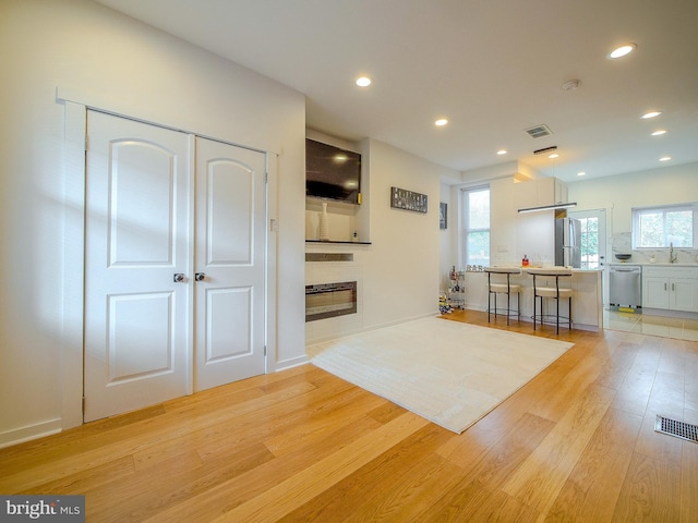 interior space featuring sink and light wood-type flooring