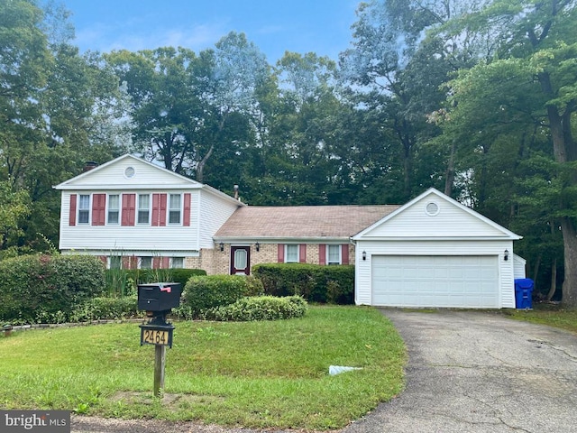 split level home featuring a garage and a front yard