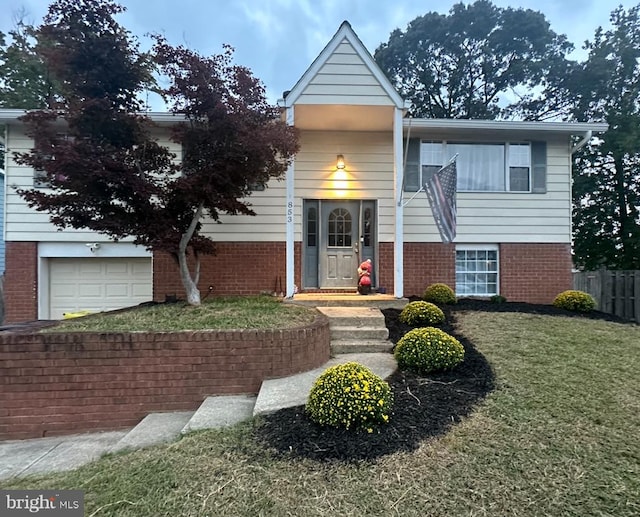 view of front facade featuring a garage and a front lawn