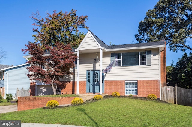 view of front of home featuring a garage and a front lawn