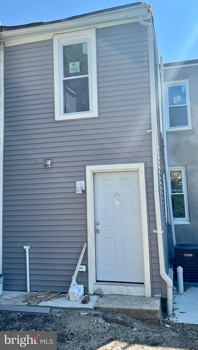 doorway to property featuring central AC unit