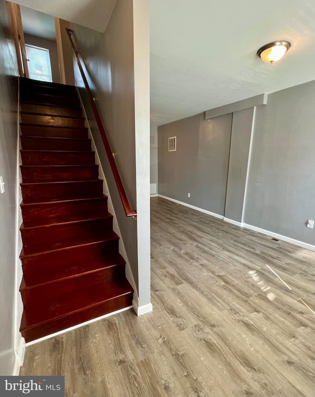 stairs with hardwood / wood-style flooring