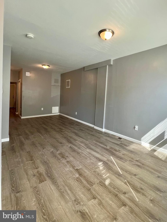 spare room featuring wood-type flooring