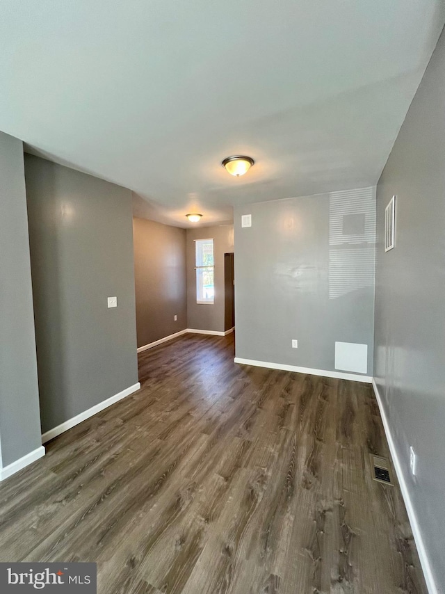 unfurnished room featuring dark hardwood / wood-style flooring