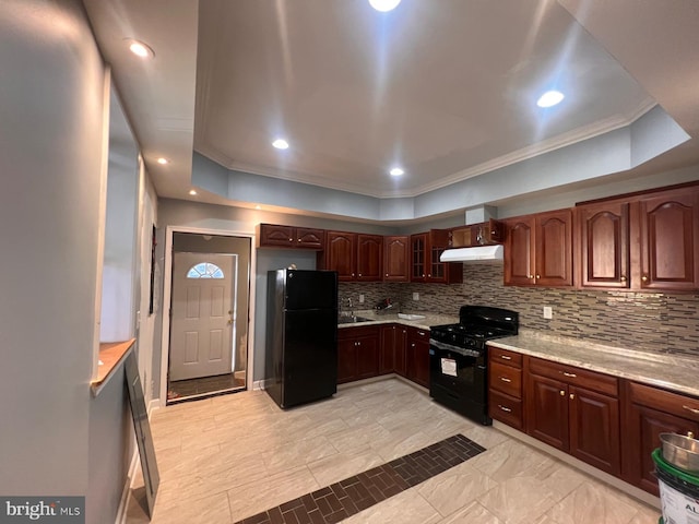 kitchen with black appliances, a raised ceiling, ornamental molding, and tasteful backsplash