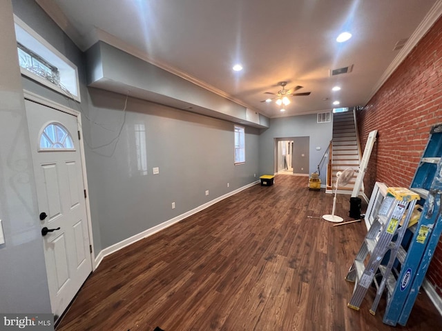 interior space featuring ceiling fan, brick wall, hardwood / wood-style floors, and crown molding