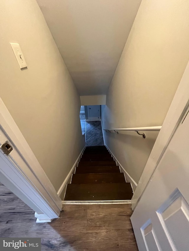 staircase featuring hardwood / wood-style flooring