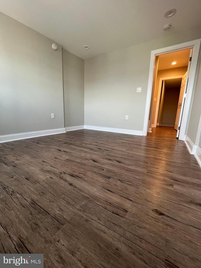 empty room featuring dark hardwood / wood-style flooring