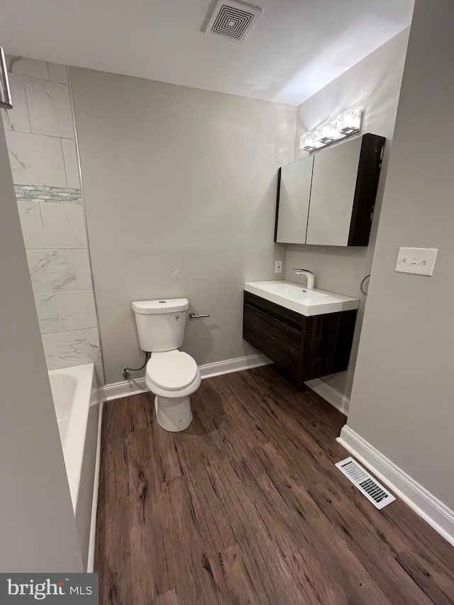 bathroom featuring hardwood / wood-style flooring, vanity, and toilet