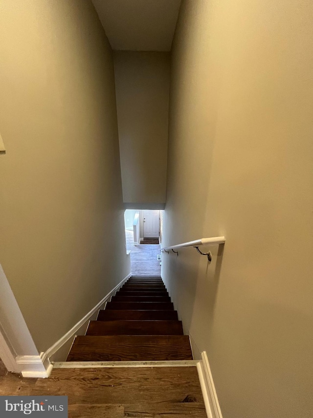 staircase with wood-type flooring