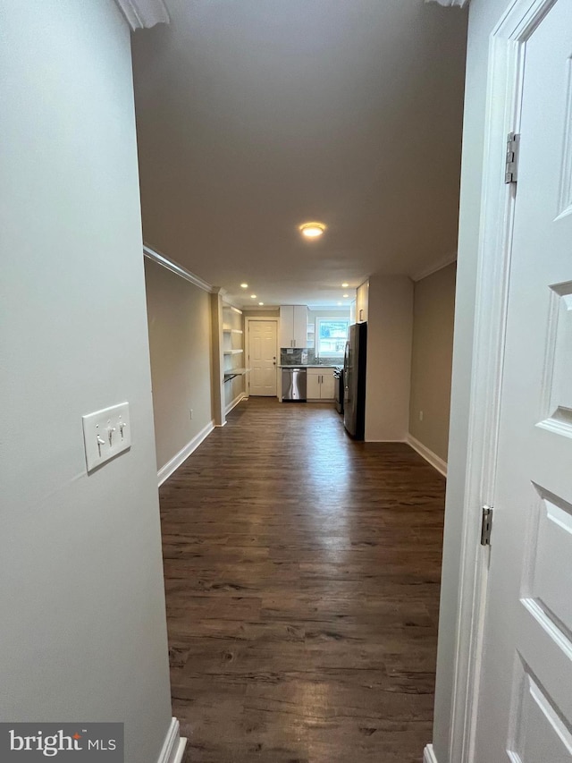 unfurnished living room with dark hardwood / wood-style flooring and crown molding