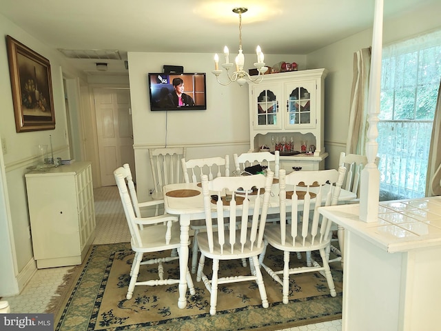 dining area featuring plenty of natural light and a chandelier