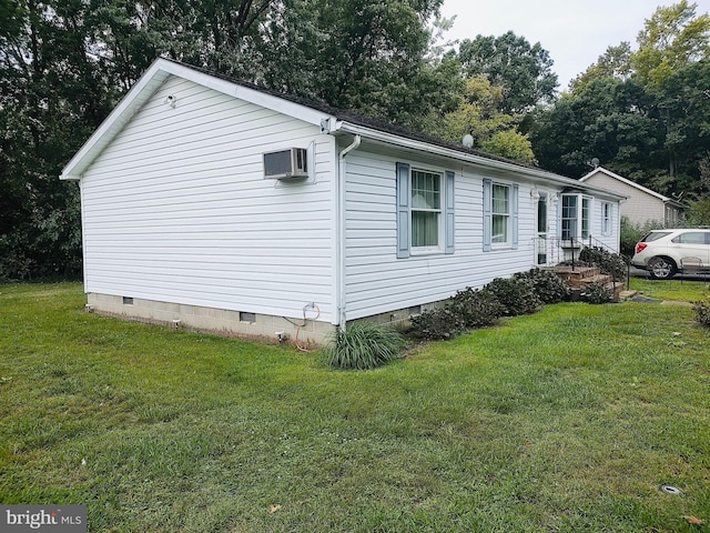 view of side of home with a lawn and a wall mounted air conditioner