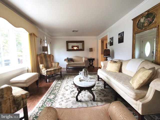 living room featuring ornamental molding, plenty of natural light, and hardwood / wood-style floors