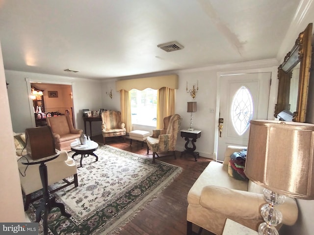 living room with dark hardwood / wood-style floors, crown molding, and a healthy amount of sunlight