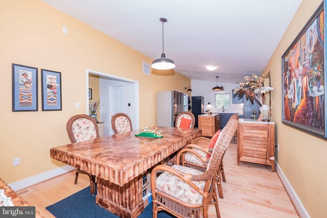 11512 Cherry Grove Dr, North Potomac, MD 20878 - dining room featuring light wood finished floors, baseboards, and visible vents