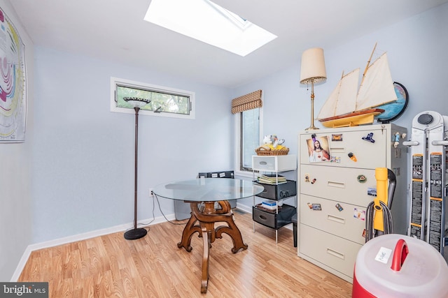 11512 Cherry Grove Dr, North Potomac, MD 20878 - home office with light wood finished floors, a skylight, and baseboards