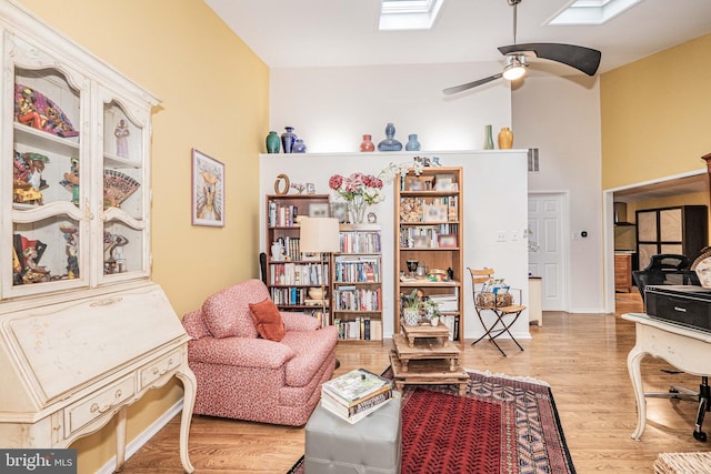 11512 Cherry Grove Dr, North Potomac, MD 20878 - living area featuring a skylight, a ceiling fan, a towering ceiling, and wood finished floors