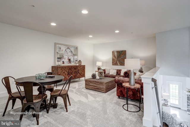 dining area featuring light carpet