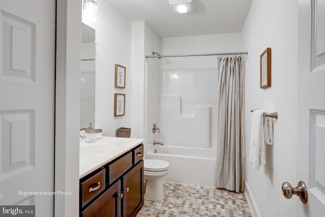 full bathroom featuring shower / bath combo, vanity, and toilet