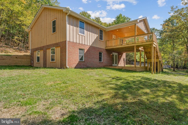 back of house with a lawn and a wooden deck