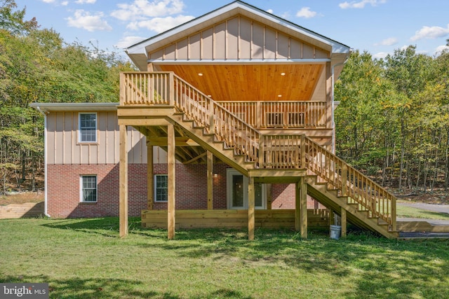 back of property featuring a deck and a yard