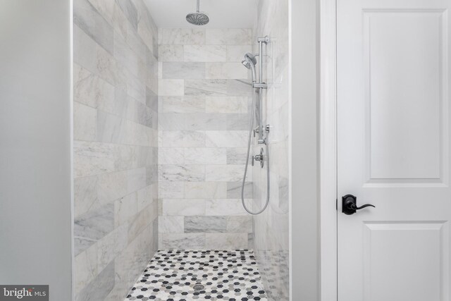 bathroom with tiled shower