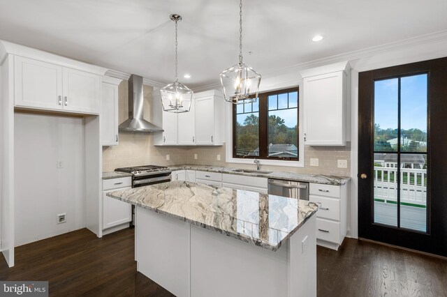 kitchen with wall chimney exhaust hood, a wealth of natural light, white cabinetry, and dark wood-type flooring