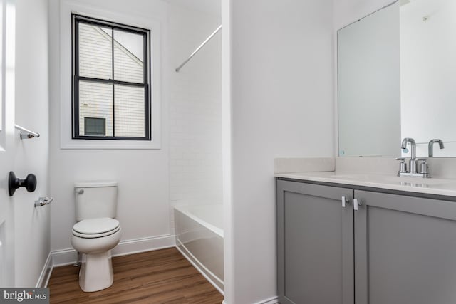 full bathroom featuring shower / bath combination, hardwood / wood-style flooring, vanity, and toilet