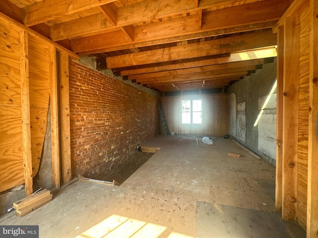 basement featuring brick wall