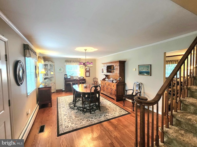 dining space with a baseboard radiator, hardwood / wood-style flooring, a healthy amount of sunlight, and crown molding