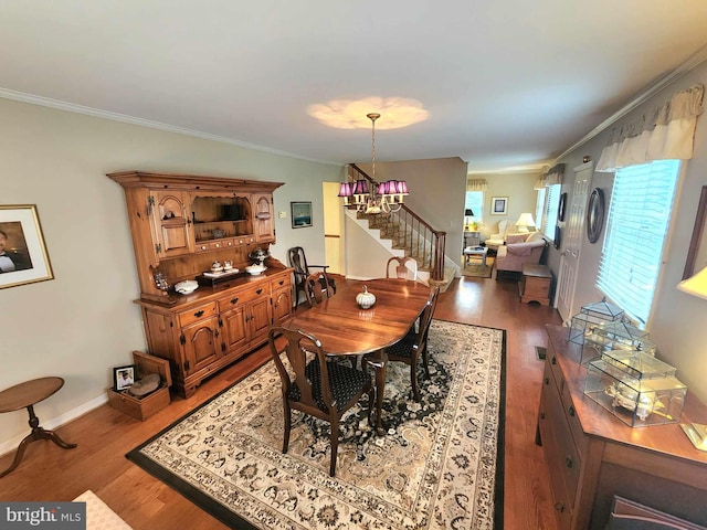 dining room with wood-type flooring and crown molding