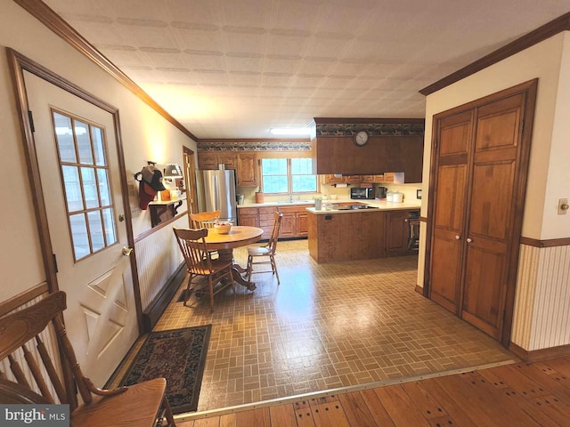 dining room featuring ornamental molding, hardwood / wood-style flooring, and sink