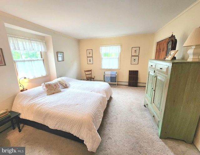 carpeted bedroom featuring ornamental molding and a baseboard heating unit