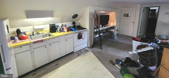 kitchen with sink, white appliances, and white cabinetry