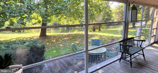 unfurnished sunroom with a water view and a wealth of natural light