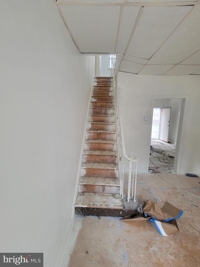 stairway featuring a paneled ceiling