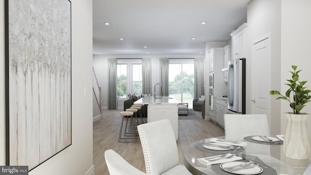 dining area featuring light hardwood / wood-style floors and sink