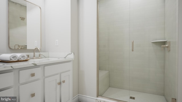 bathroom with vanity and a shower with door