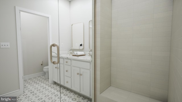 bathroom with a shower, vanity, and toilet