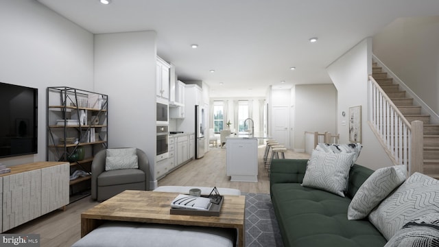 living room featuring light hardwood / wood-style flooring and sink