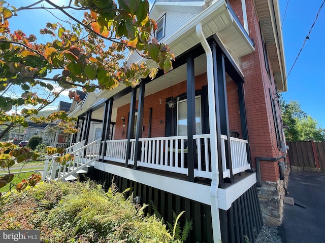 view of property exterior with covered porch