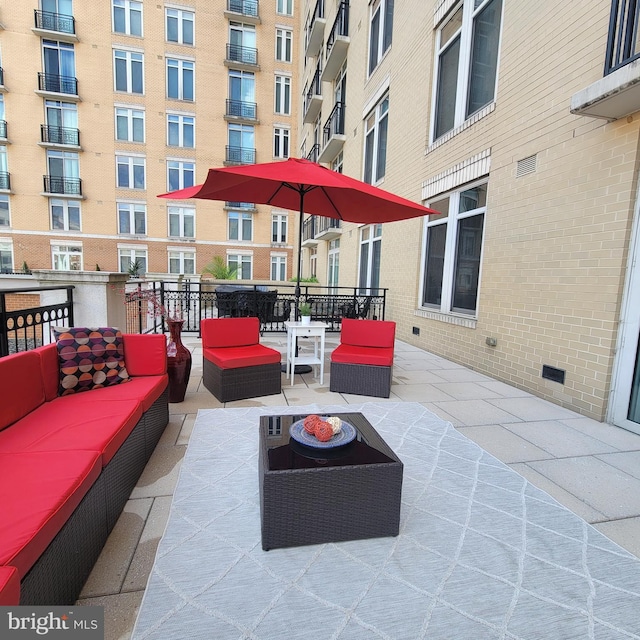 view of patio / terrace featuring a balcony and an outdoor living space