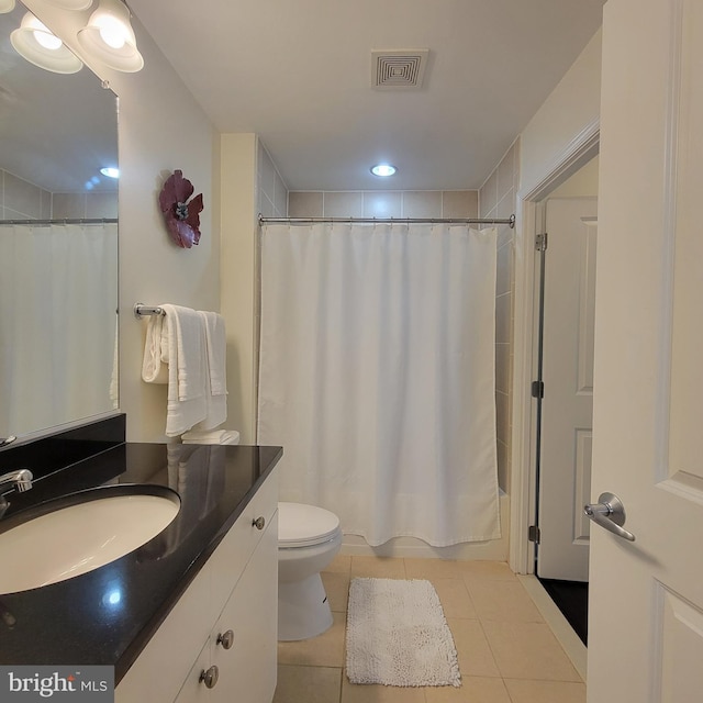 bathroom featuring tile patterned floors, curtained shower, vanity, and toilet