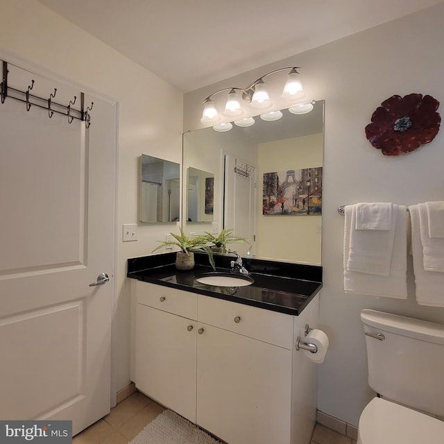 bathroom with vanity, toilet, and tile patterned floors