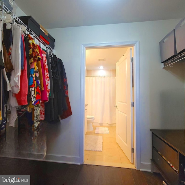 spacious closet with tile patterned floors