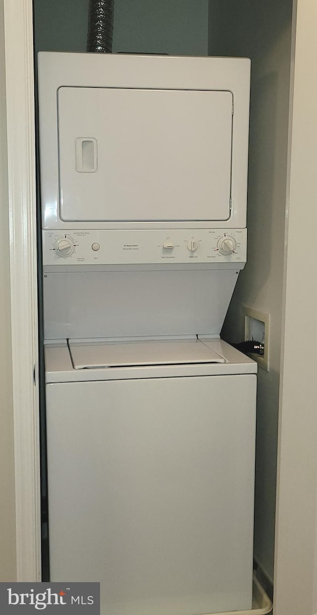 washroom featuring stacked washer and dryer