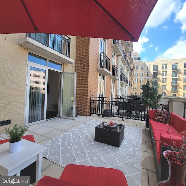 view of patio featuring a balcony