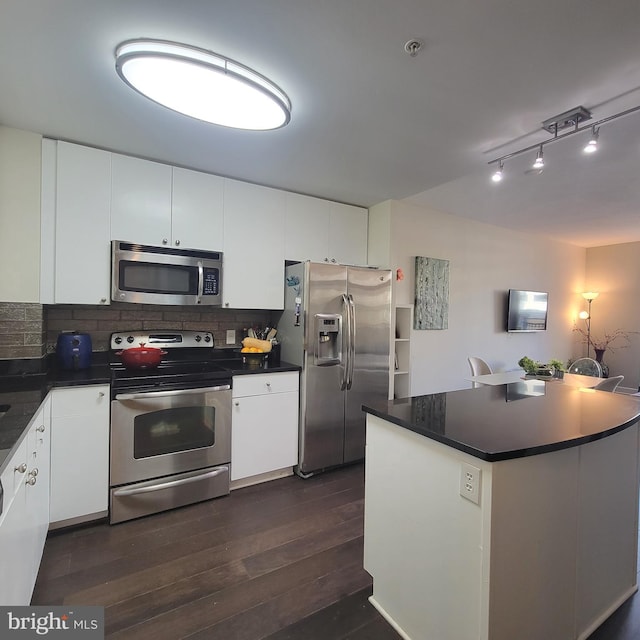 kitchen featuring backsplash, white cabinetry, dark hardwood / wood-style flooring, and stainless steel appliances